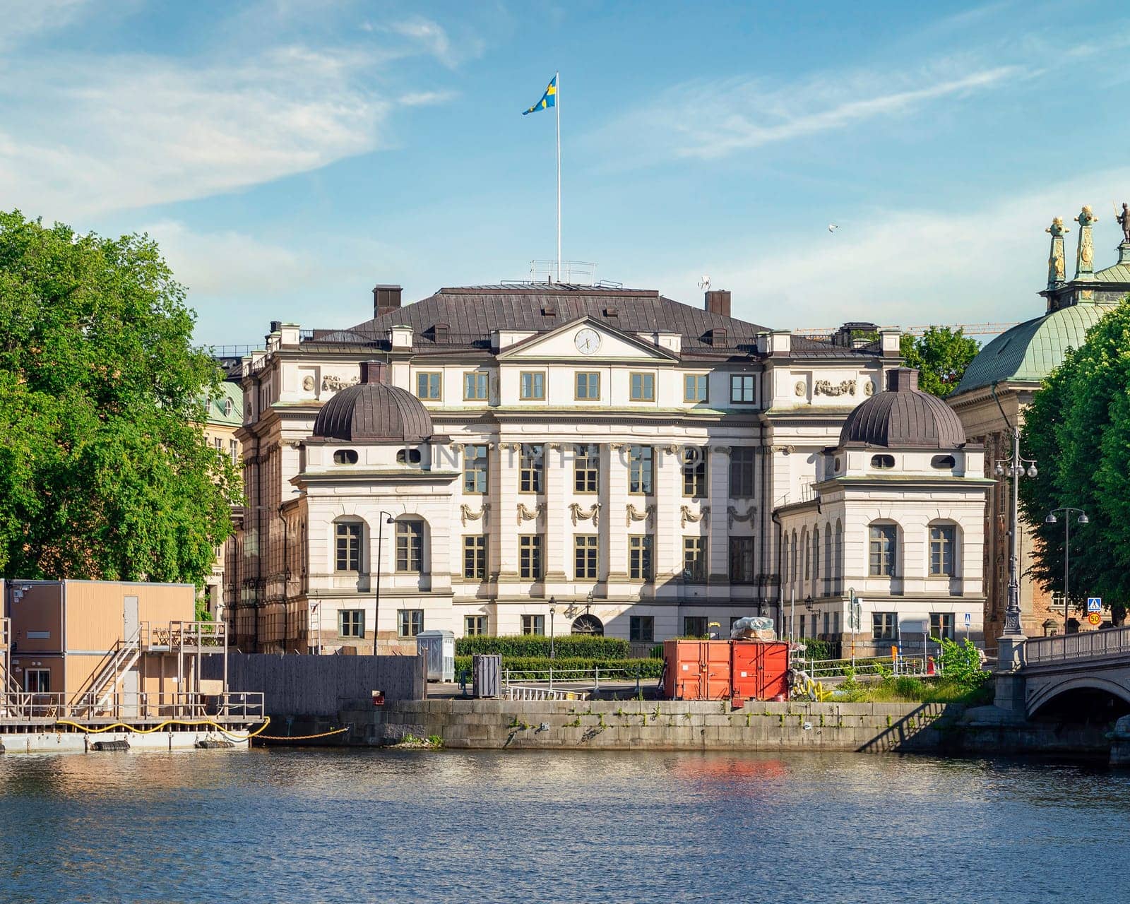 Supreme Court of Sweden building, or Hogsta Domstolen, abbreviated HD, overlooking Norrstrom river, located in the old city of Stockholm, or Gamla stan, in a summer day, Stockholm, Sweden