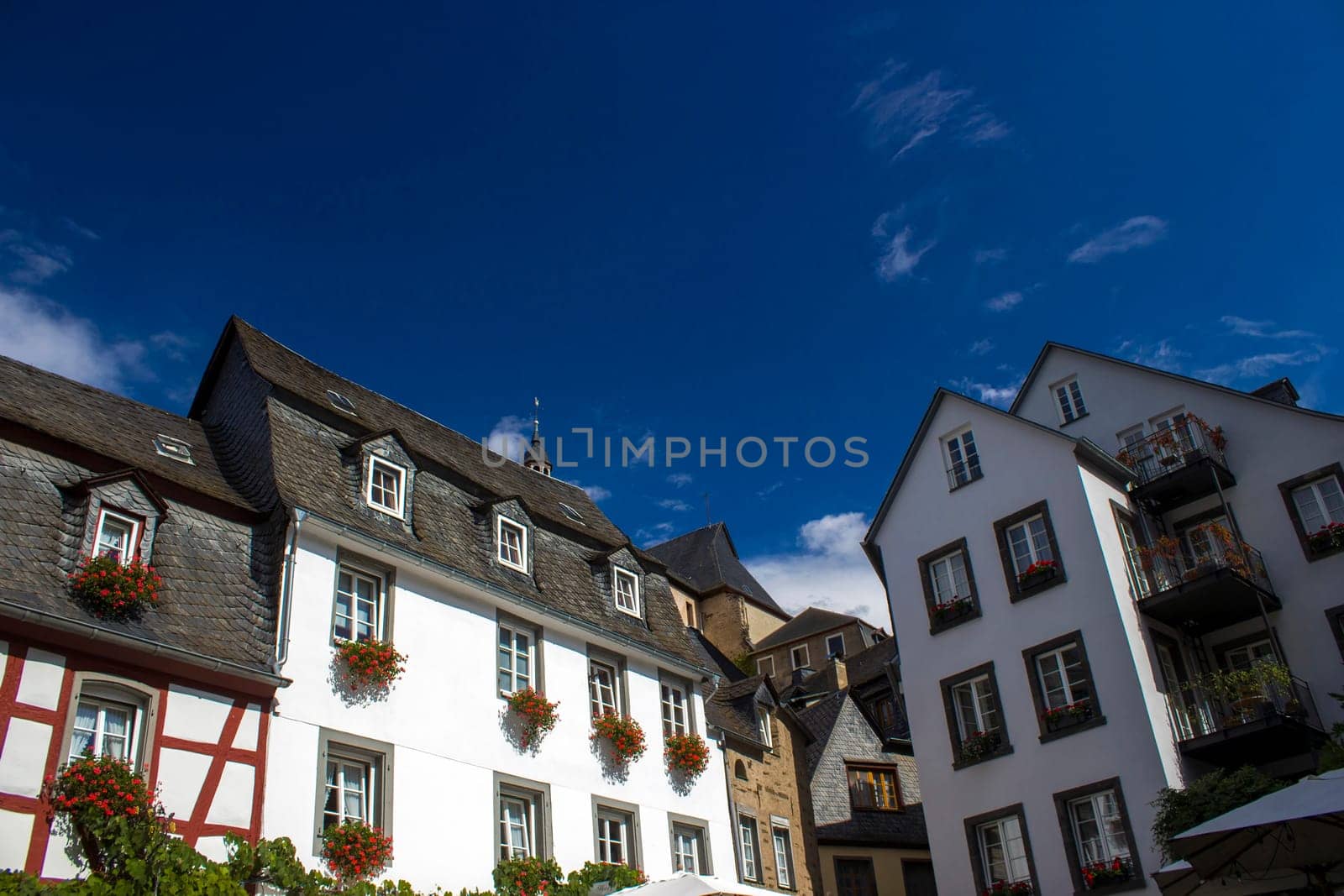 Beilstein - historic village along the river Moselle with old half-timbered houses and the ruins of castle Metternich on top of the hills, Germany