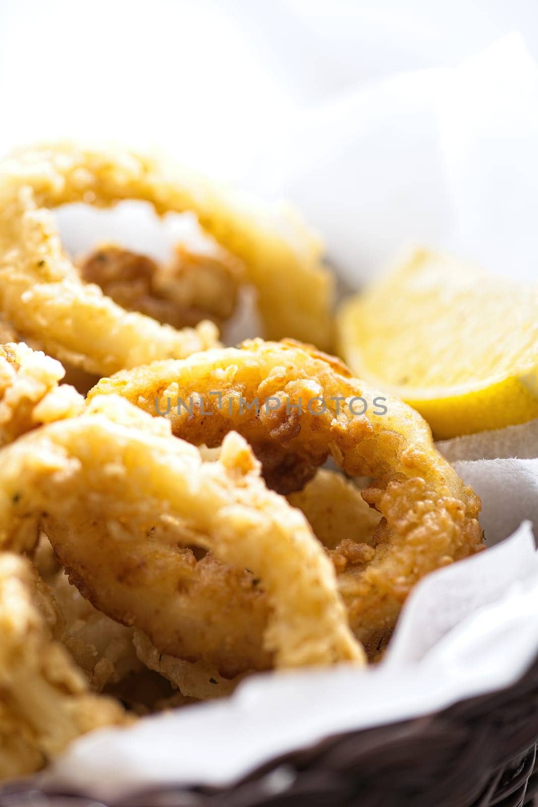 close up of basket of golden italian fried calamari