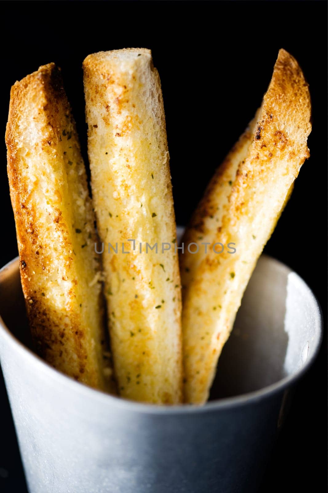 close up of sticks of golden garlic bread