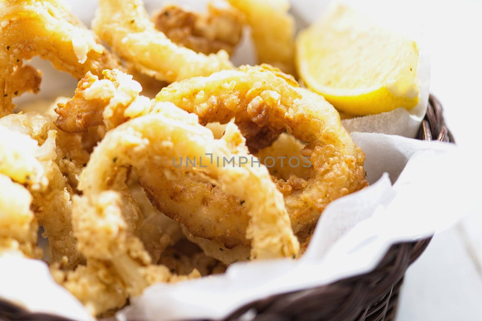 close up of basket of golden italian fried calamari