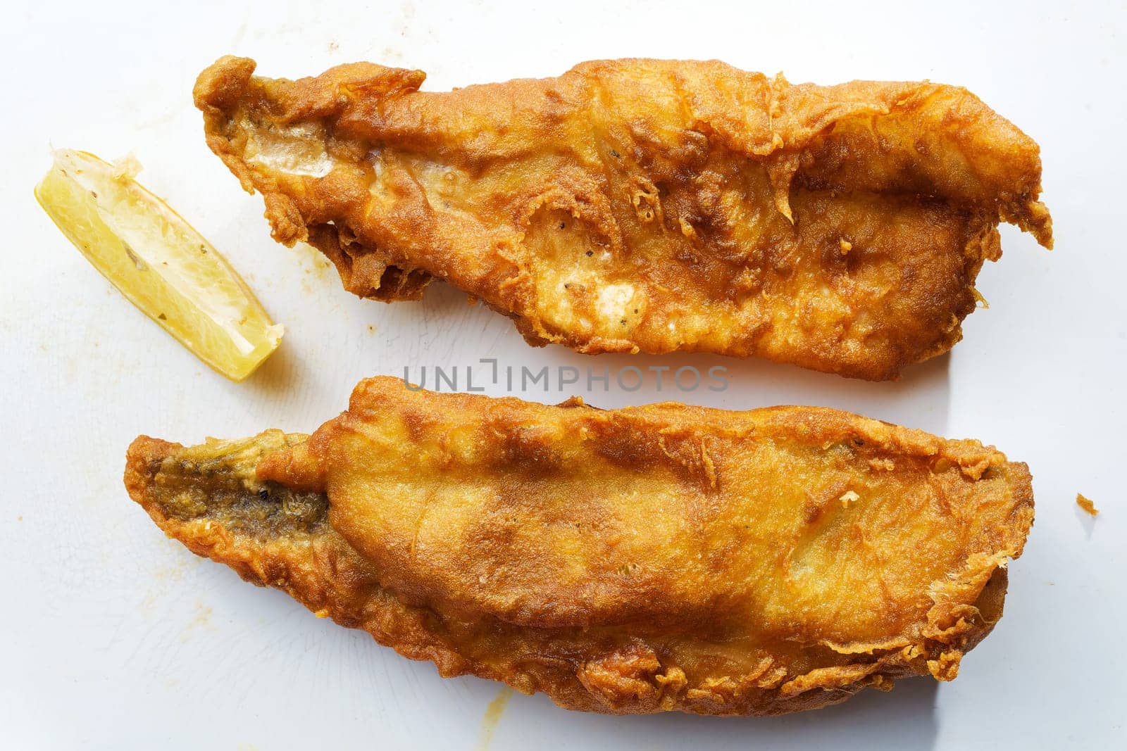 close up of traditional golden english fish and chips