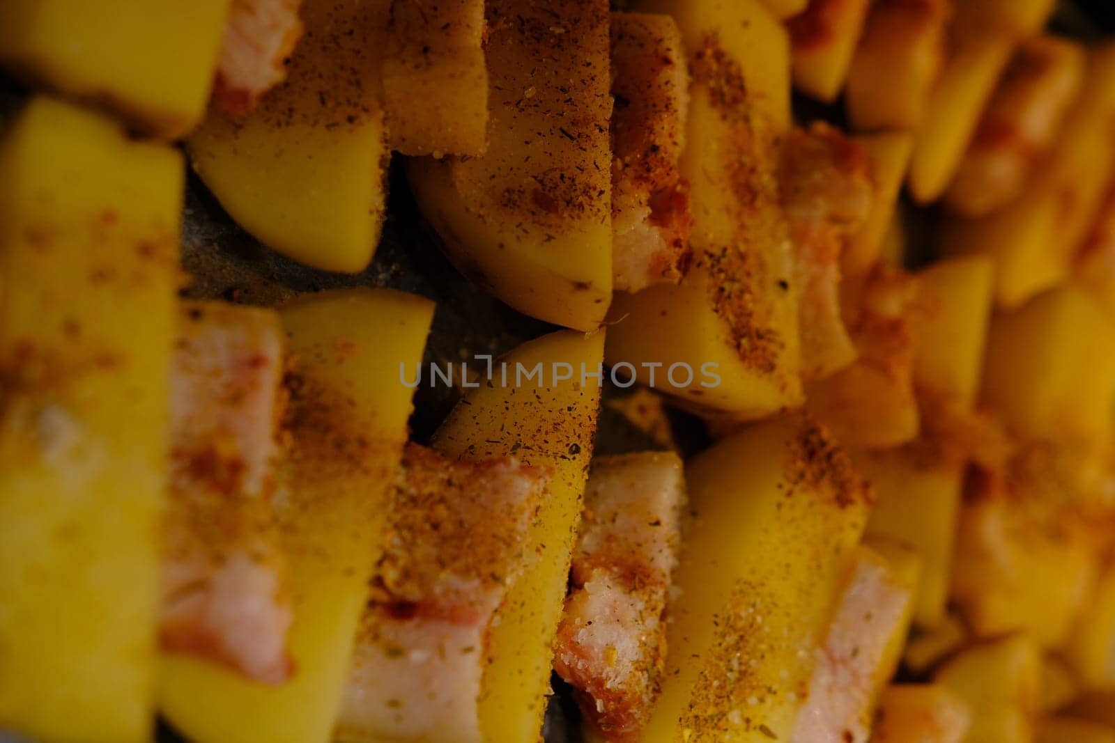 Delicious Potato Bratkartoffeln With Bacon close up in the plate on ready to bake.