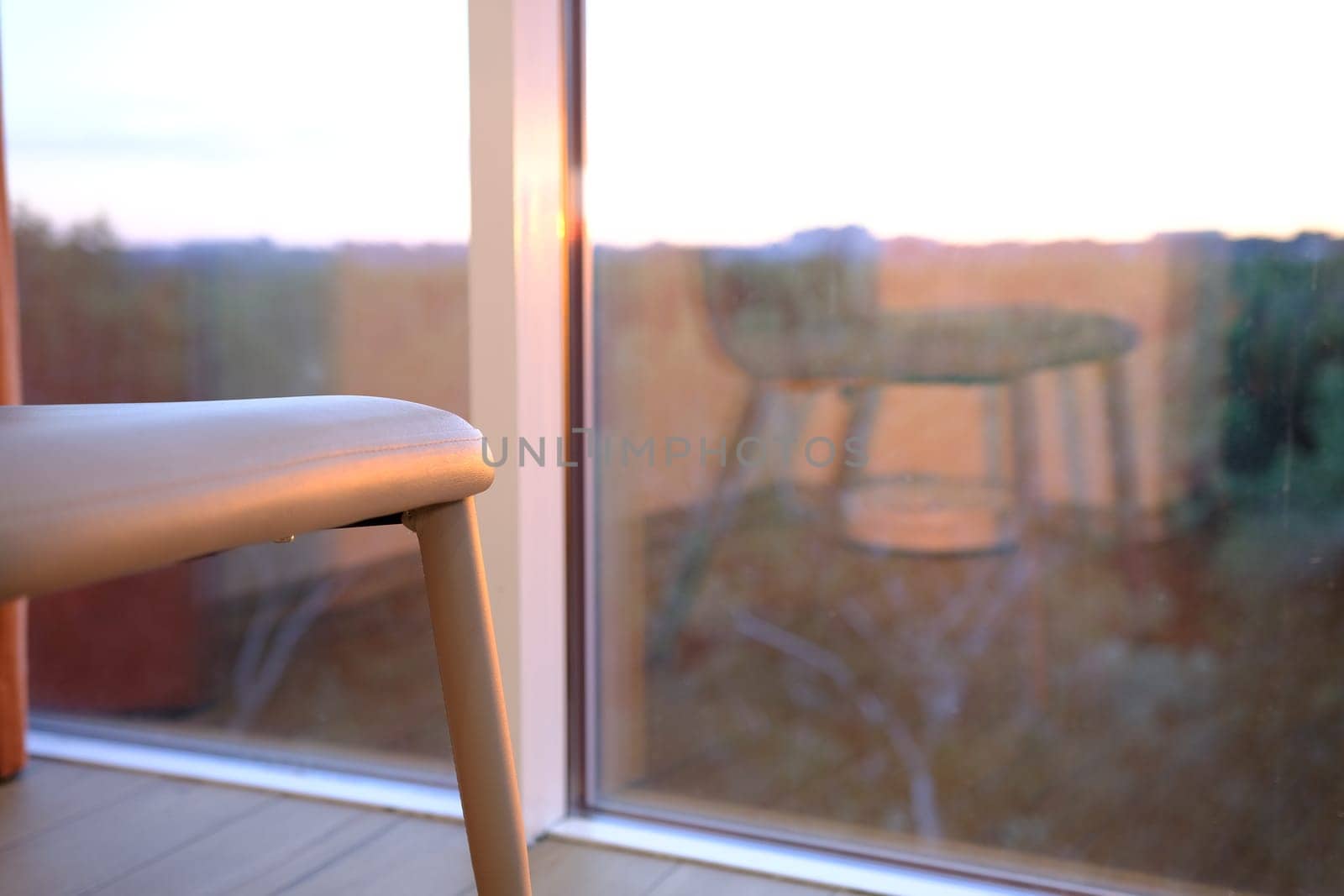 modern bliege chair in empty office space with large window, vintage picture style process,copy space