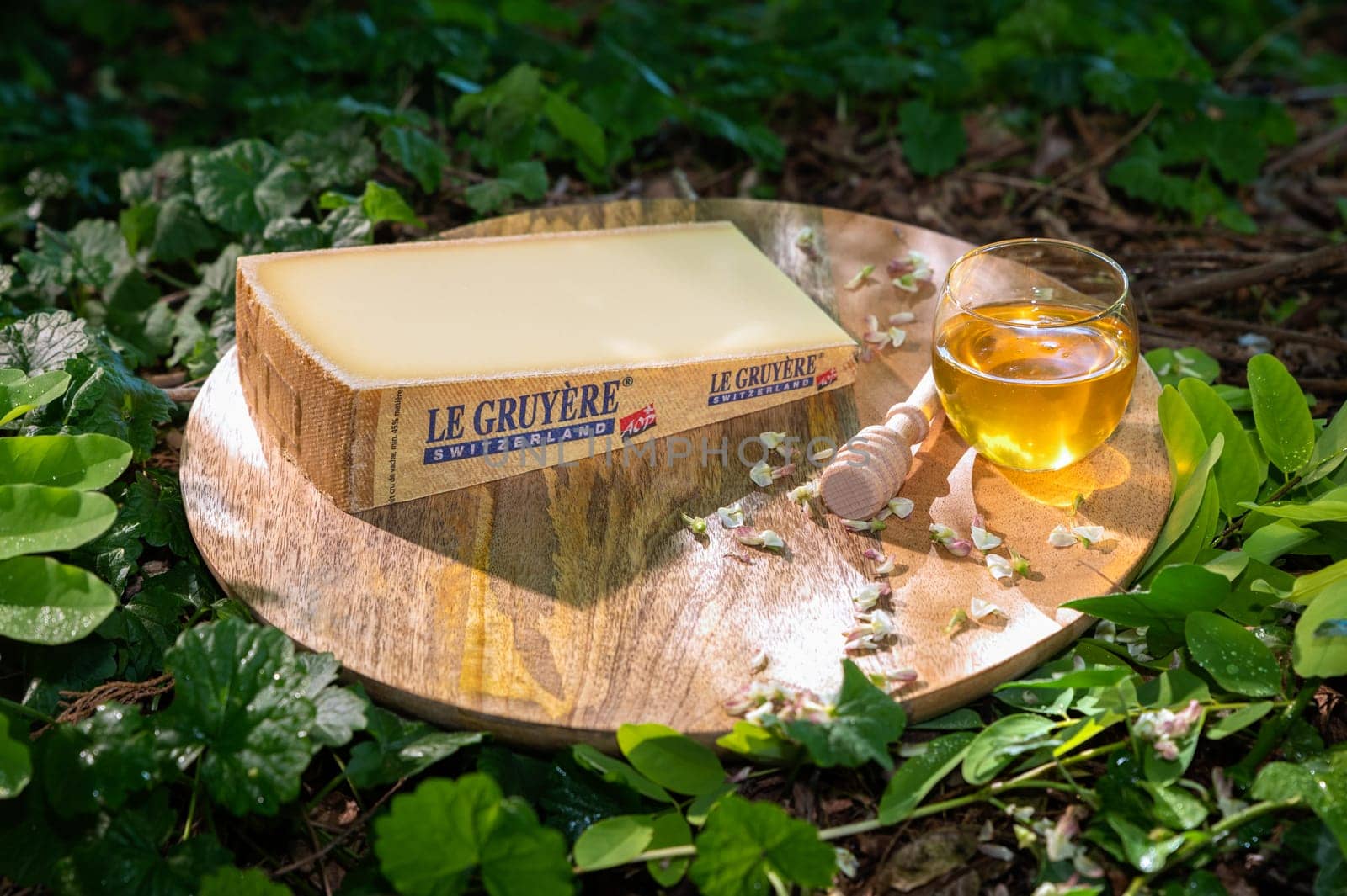 July 11 2022, Lyon, France : Switzerland cheese : Le Gruyère AOP swiss and honey cup, famous swiss cheese in a natural background