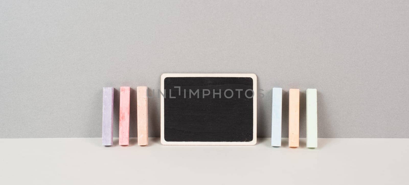 Blank chalkboard with colorful chalk, back to school, education concept