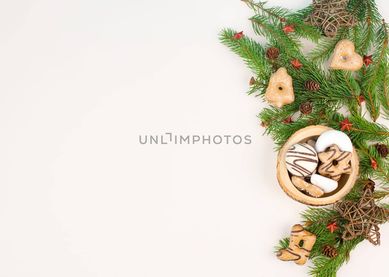Christmas tree made from fir branches, red stars and a cinnamon stick as the trunk, greeting card with copy space
