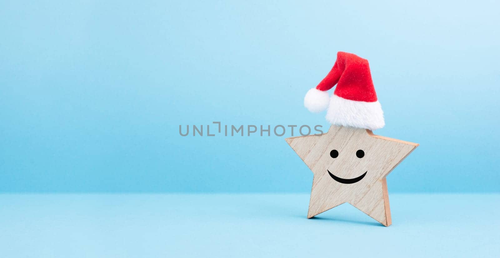 Star with a happy smiling face expression, red christmas hat, winter greeting card and banner, copy space