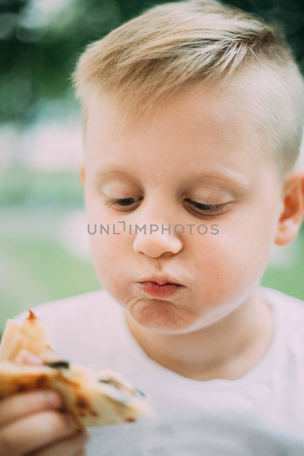 Little Boy Eating Pizza In Cafe In Summer Day.