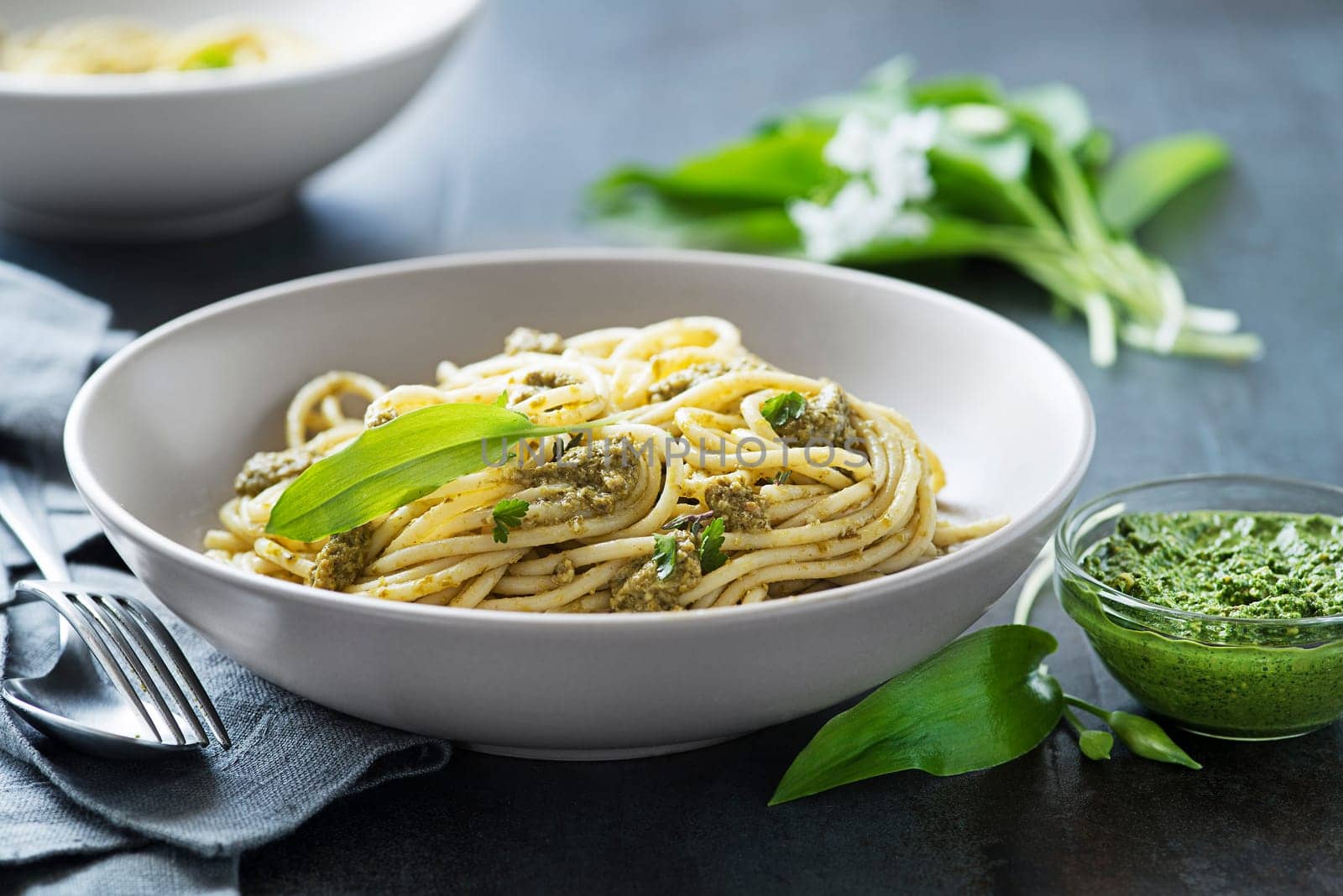 Making Fresh pasta with ramson or wild garlic pesto closeup. Healthy spring food concept