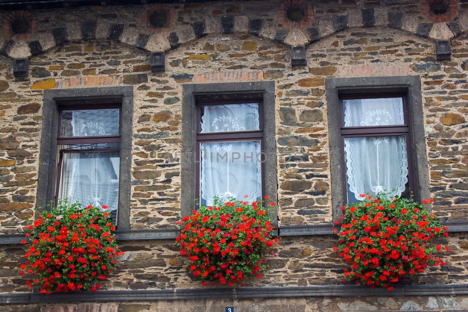 Old Building in Treis-Karden, windows with flowers, Rheineland-Palatinate, Germany