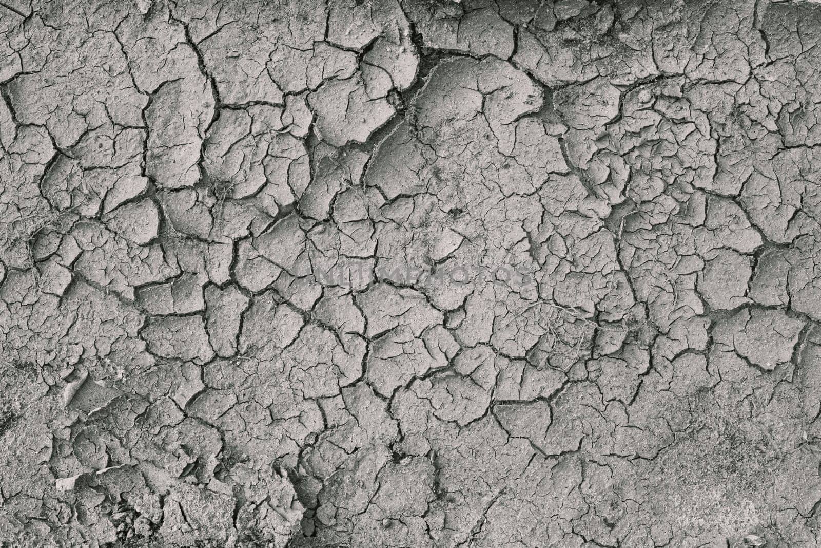 Background Of Dry Cracked Soil Dirt Or Earth During Drought. Dry Cracked Earth Depicting Severe Drought Conditions.