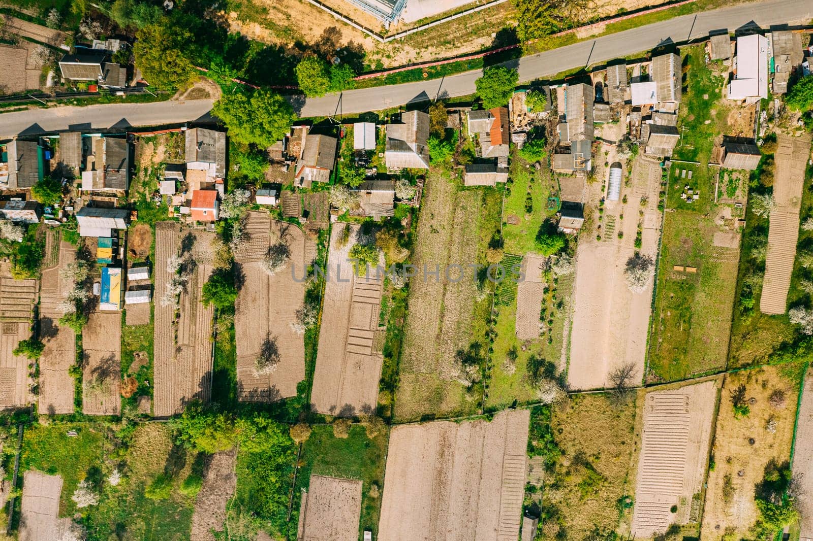 Russia. Aerial View Of Small Town, Village Cityscape Skyline In Summer Day. Residential District, Houses And Vegetable Garden Beds In Bird's-eye View.