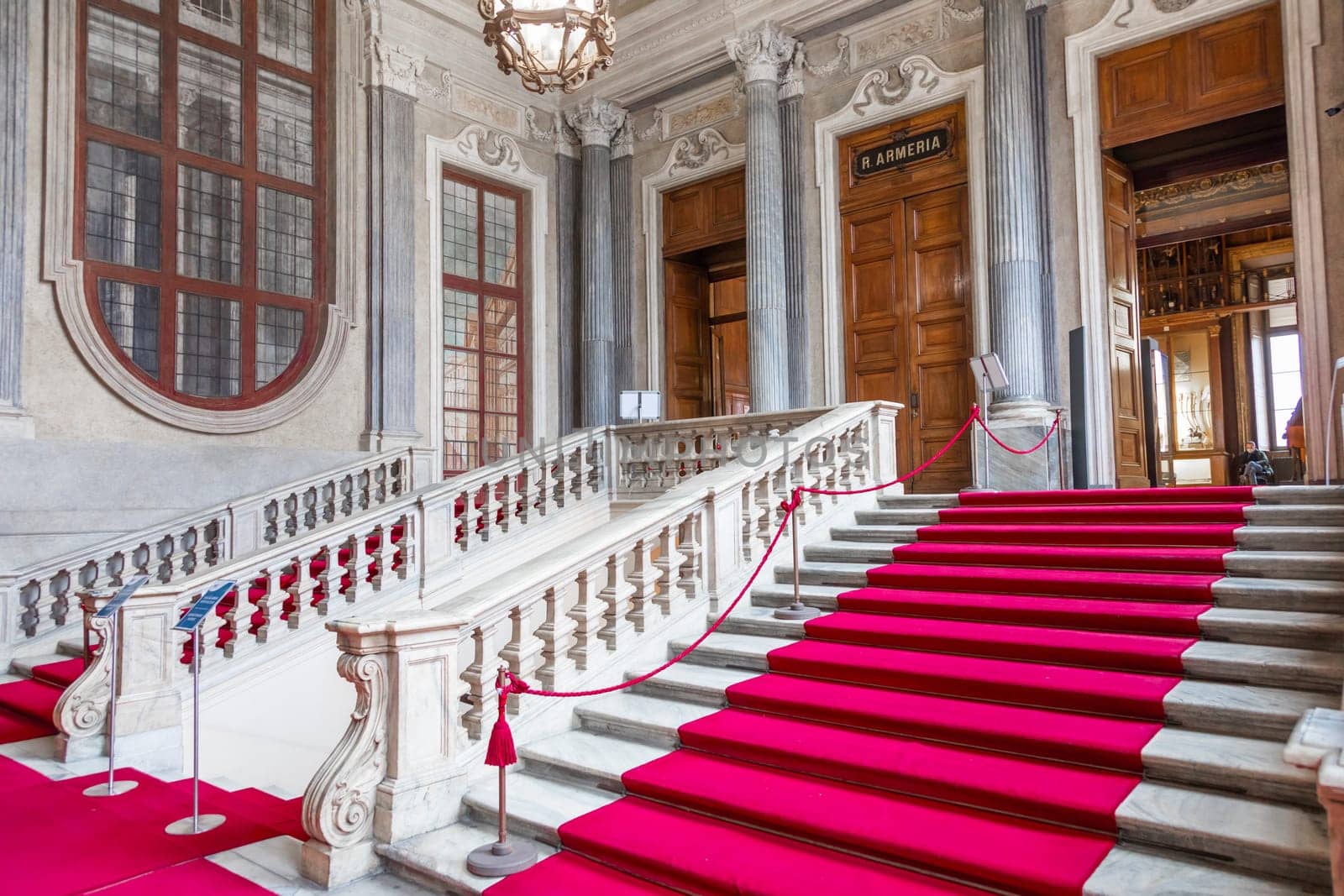 Turin, Italy - Circa January 2022: red carpet in Royal Palace - luxury elegant marble stairway
