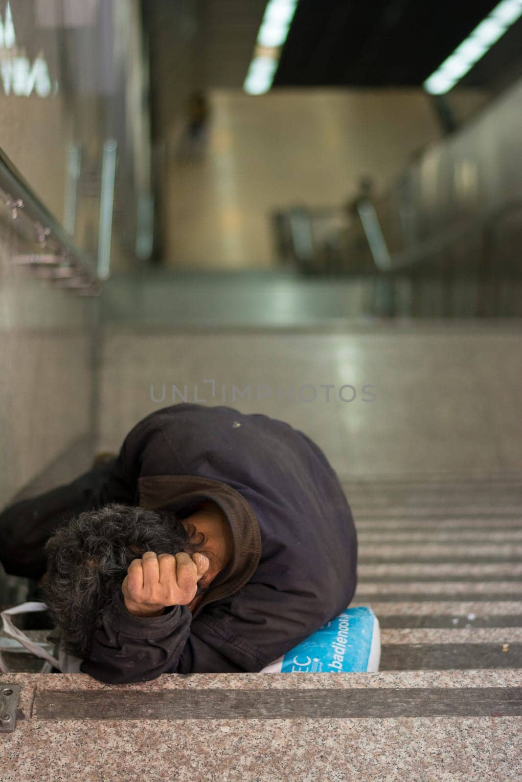 A homeless male slept at metro station steps