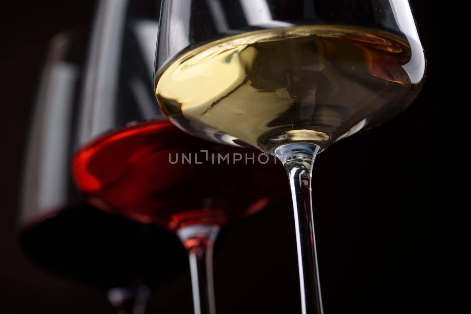 Closeup of three glass of red, rose and white wine over black background. Wine card menu design. Wine list still life.