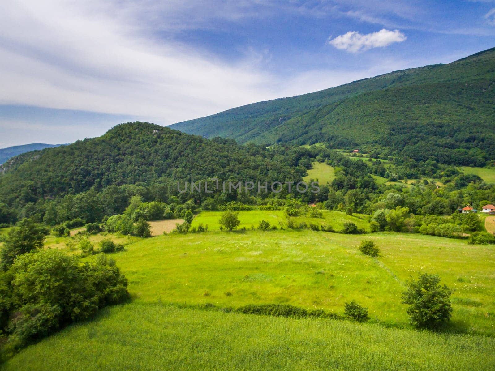 Aerial view of mountain green landscape. Highland hills and meadows form above.