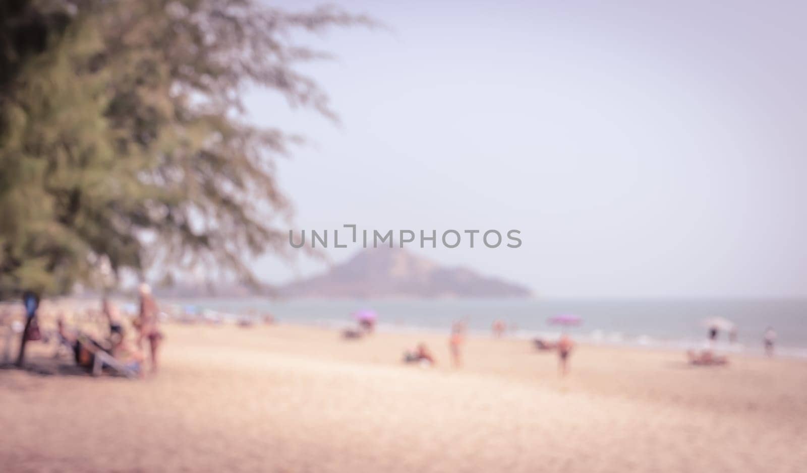 Blur sea image background of people on the beach in vintage color style