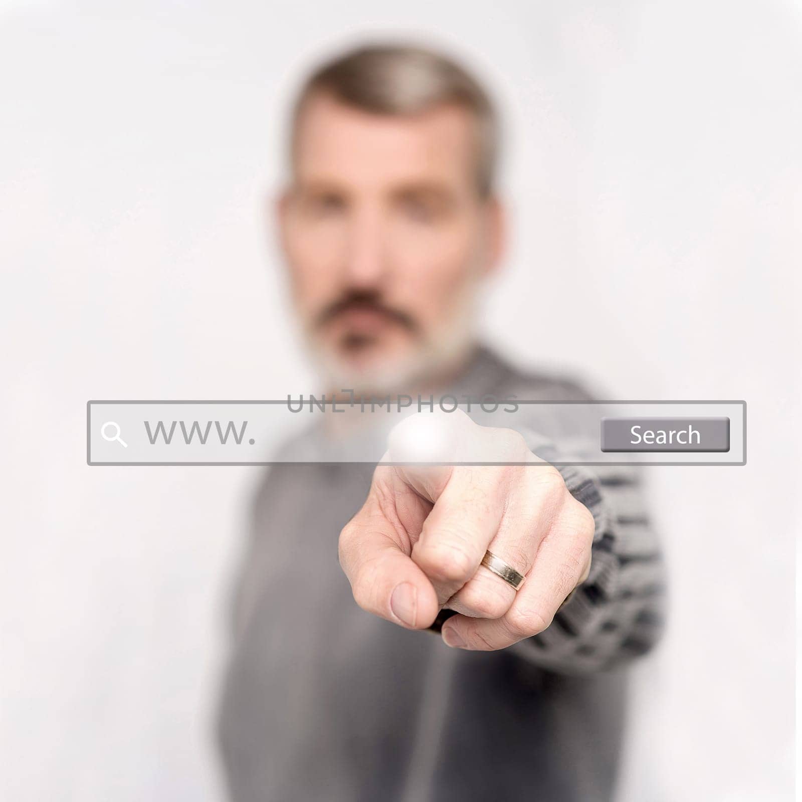 Senior man touching web search bar on virtual screen.