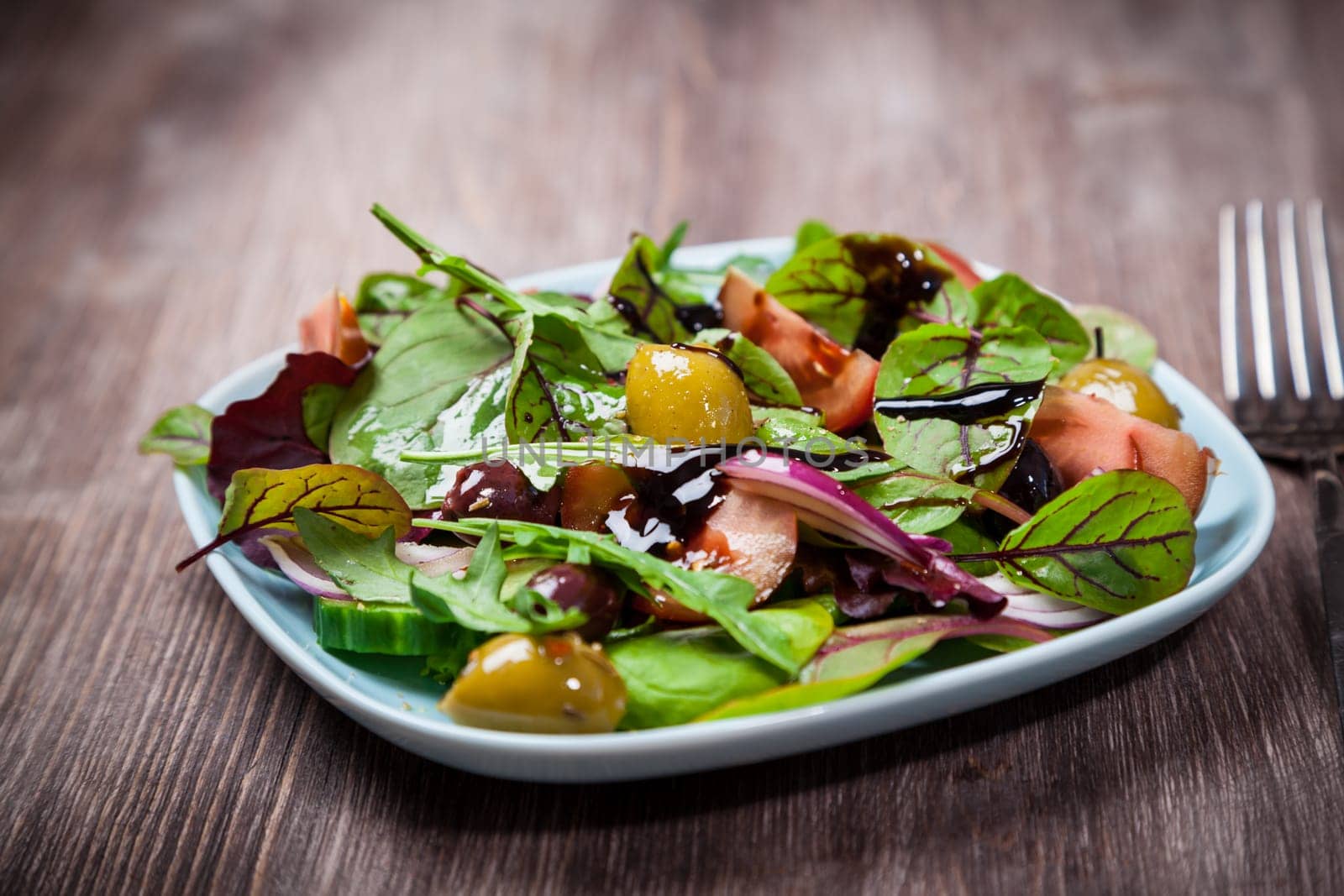 Mixed low calorie salad with olives and fresh avocado