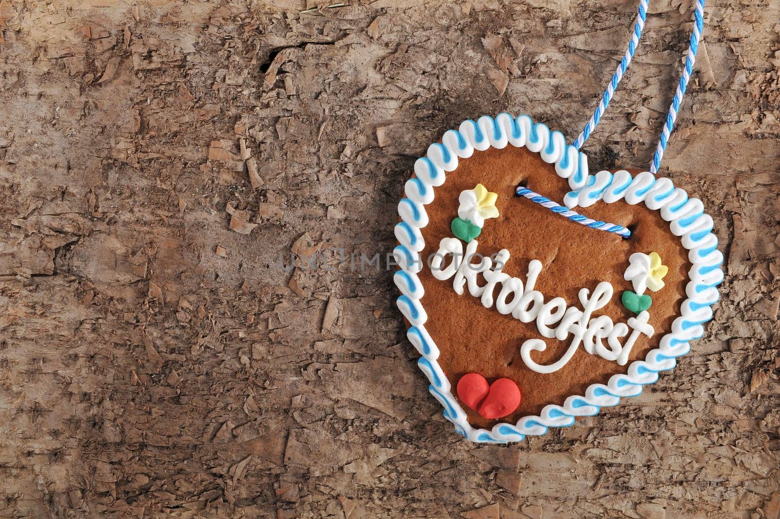 original bavarian oktoberfest gingerbread heart in real brown tree bark\n