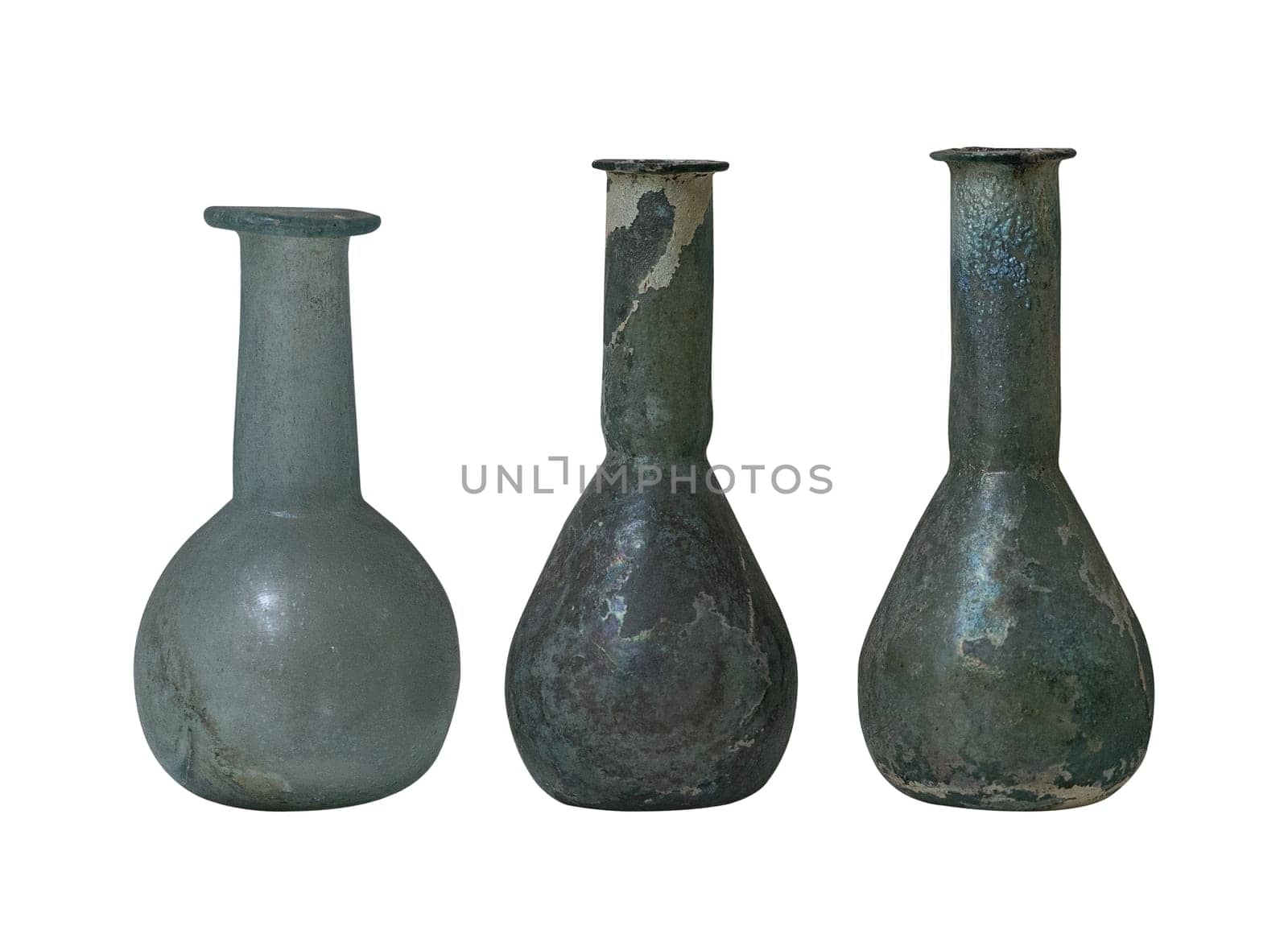 front view closeup of three weathered antique roman glass bottle vials with long neck isolated on white background