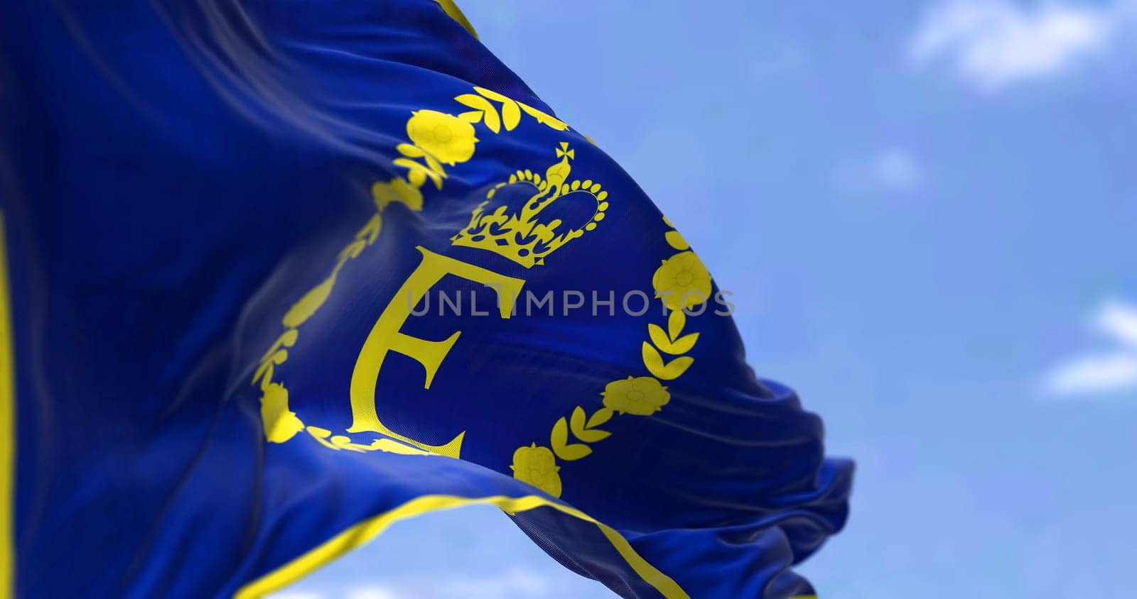 the personal flag of Queen Elizabeth II flying in the wind. Tradition and British monarchy