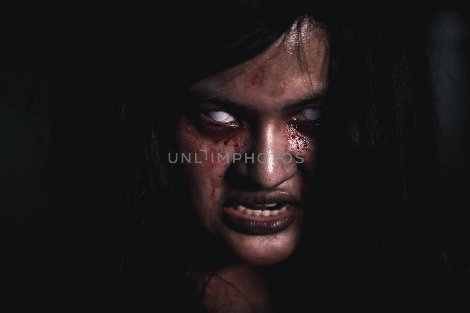 Horror bloodthirsty woman ghost or zombie she is horror scary with open mouth at dark night, Screaming zombie female face with blood, Happy halloween day festival concept