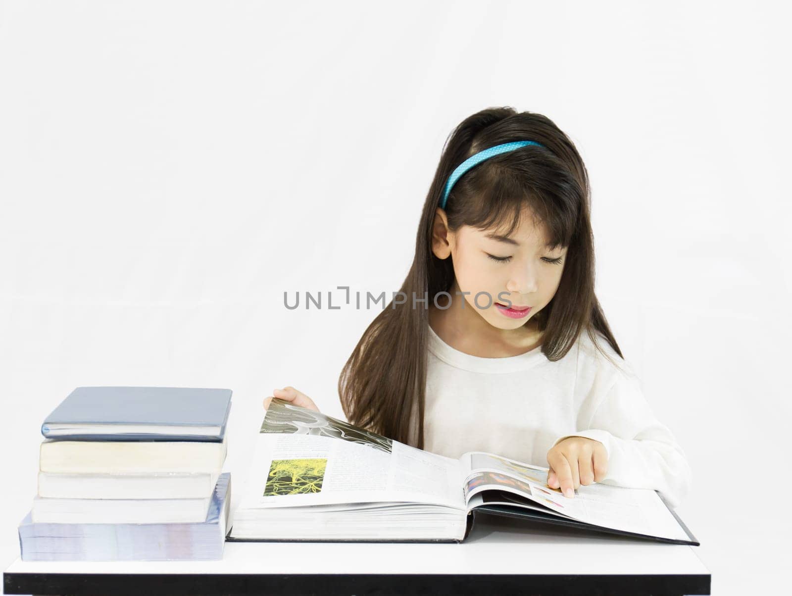 The young student reading the book on a white background