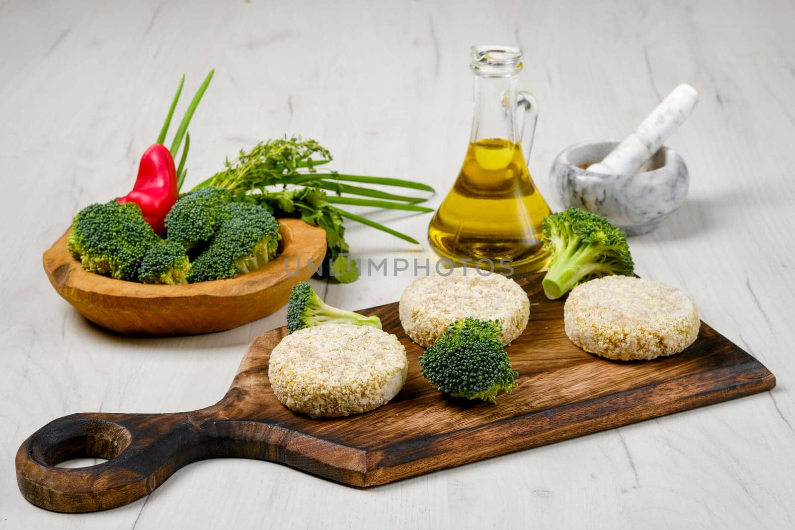 Semifinished homemade chicken cutlet with broccoli on a wooden serving board