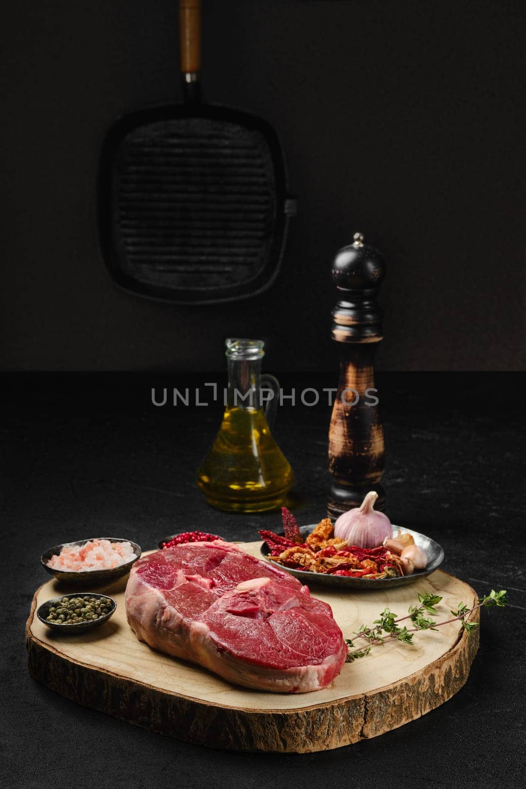 Raw fresh lamb center cut leg steak with spice on the kitchen table