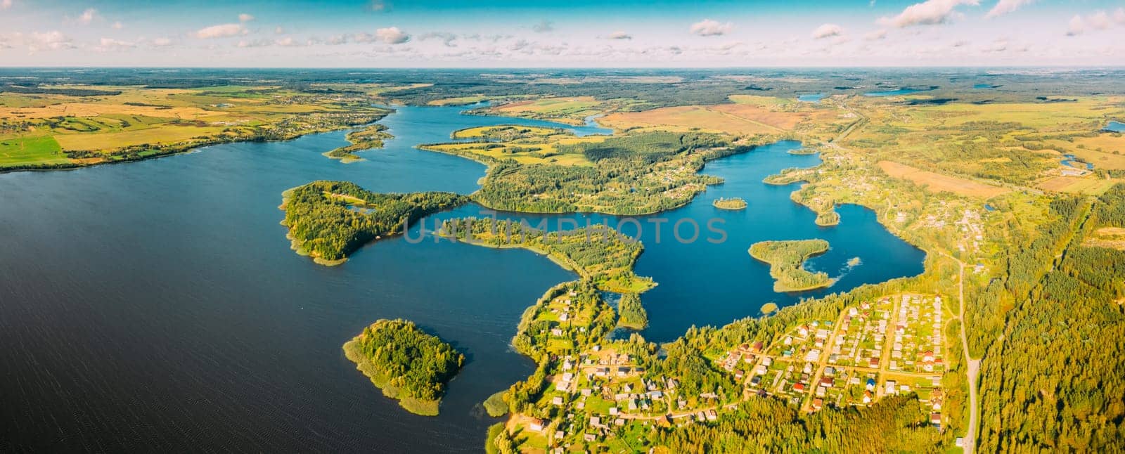 Lyepyel District, Lepel Lake, Beloozerny District, Vitebsk Region. Aerial View Of Residential Area With Houses In Countryside. Top View Of Island Pension Lode From High Attitude In Autumn Sunny Day. Bird's Eye View Of Lyepyel Cityscape Skyline. Panoramic View.