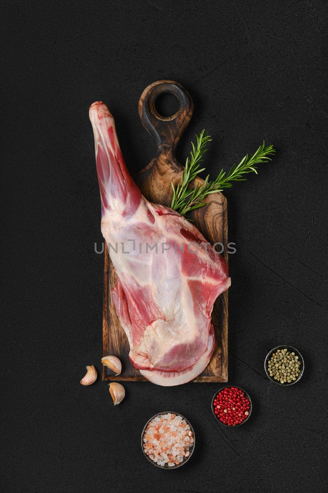 Top view of raw fresh lamb short cut leg, sirloin off on wooden board