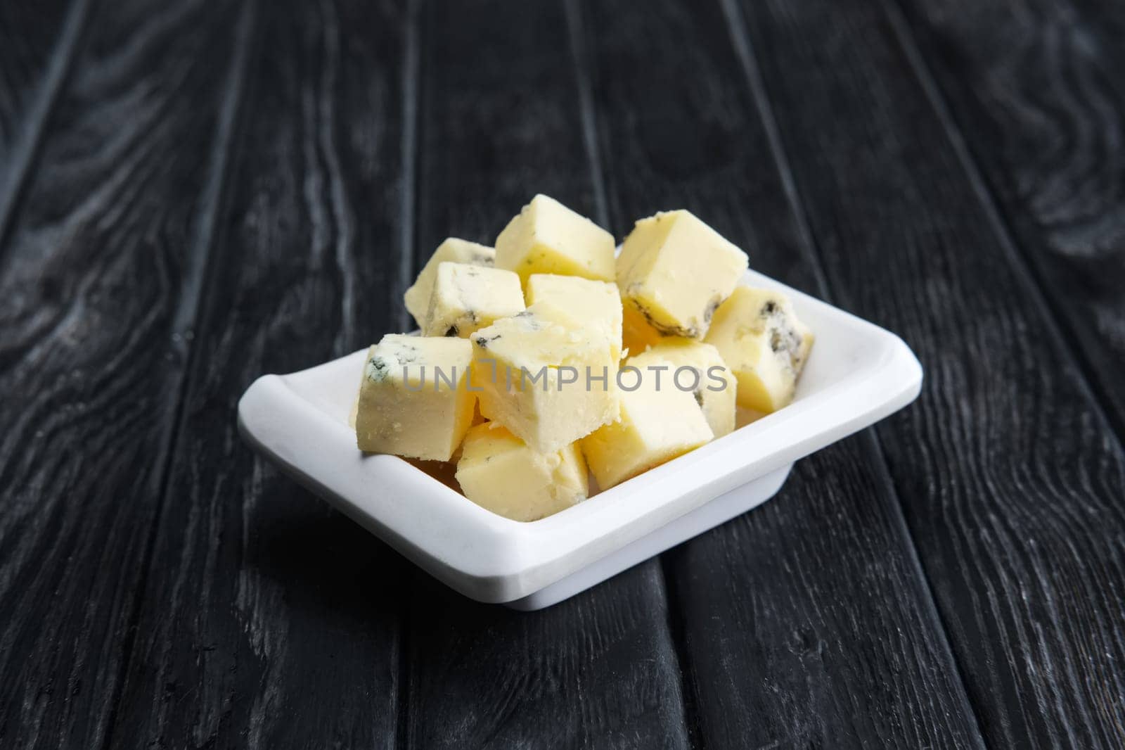 Small square pieces of blue cheese. Cheese with fungus.