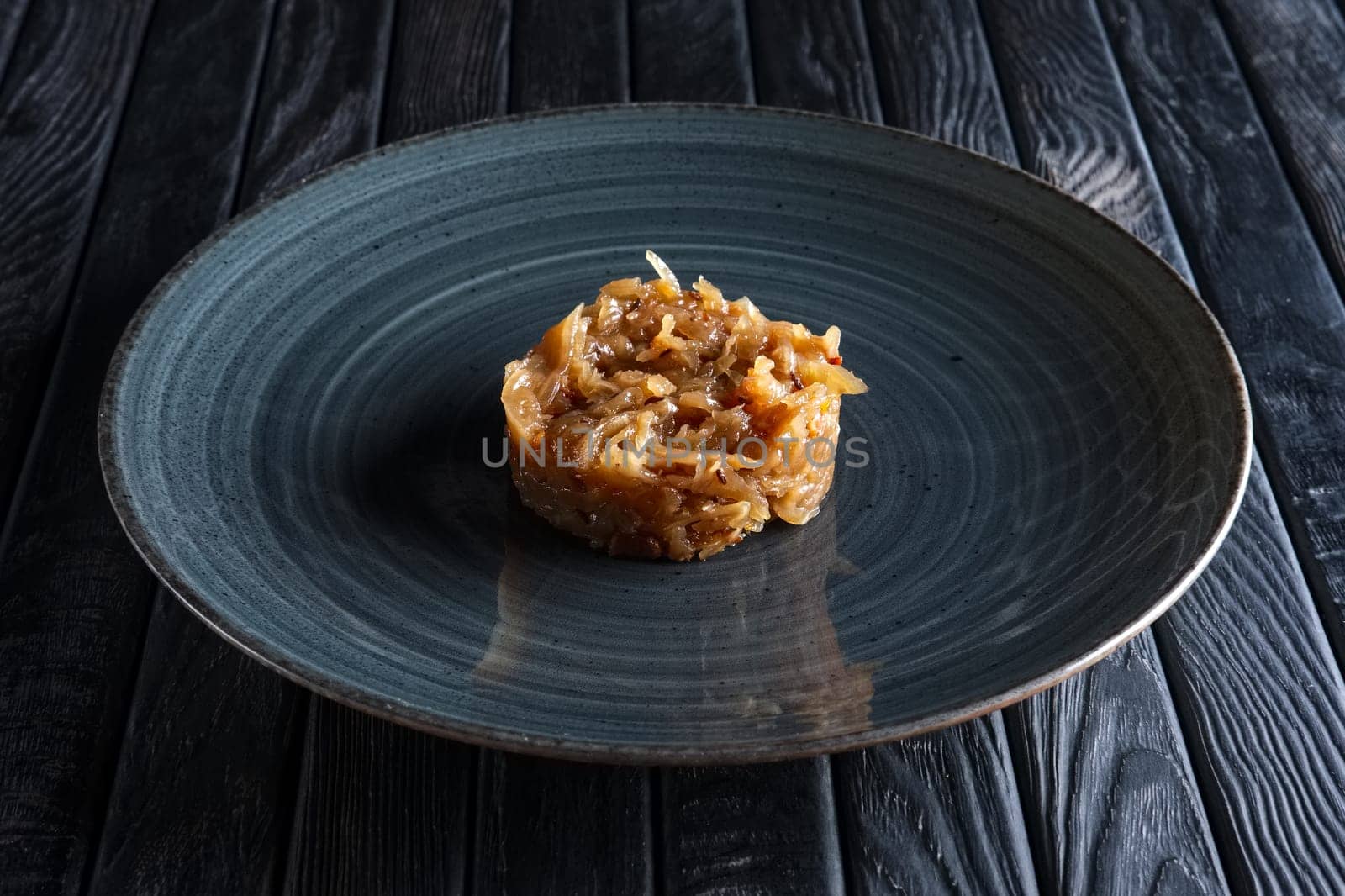 Plate with onion marmalade. Candied onion jelly.
