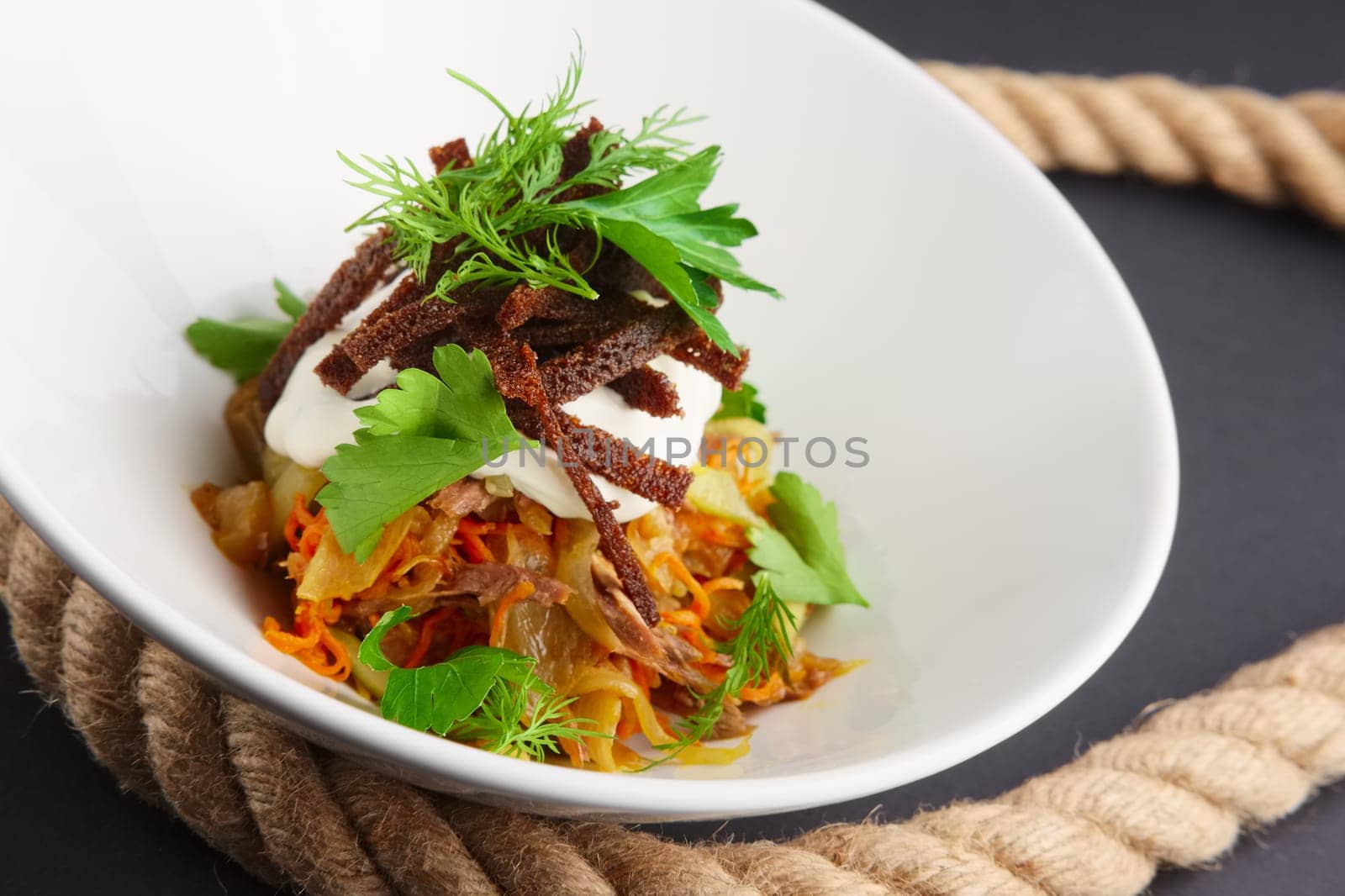 Authentic salad with bean, cabbage and pickled cucumber. Closeup view.