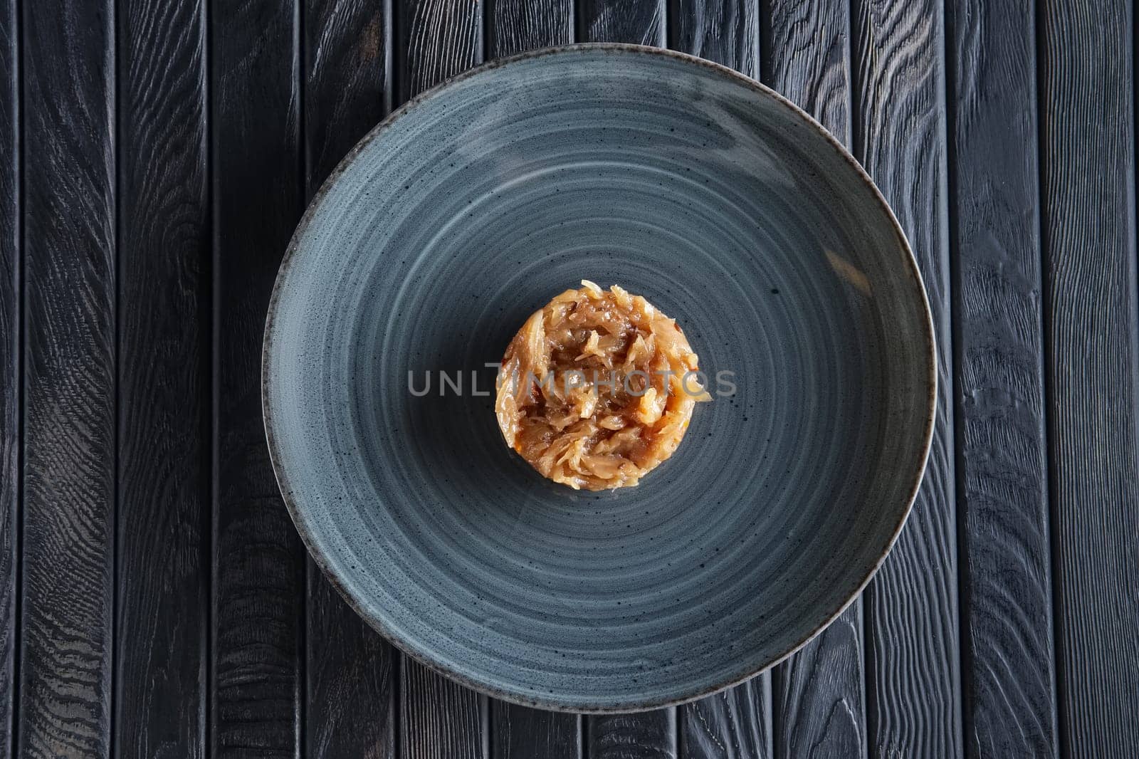 Top view of plate with onion marmalade. Candied onion jelly.