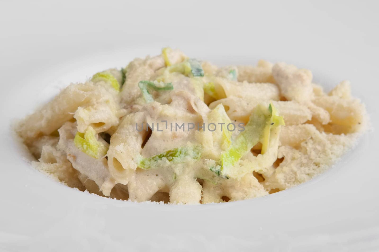 Delicious spaghetti bolognese garnished with parmesan cheese and basil. Selective focus photo.
