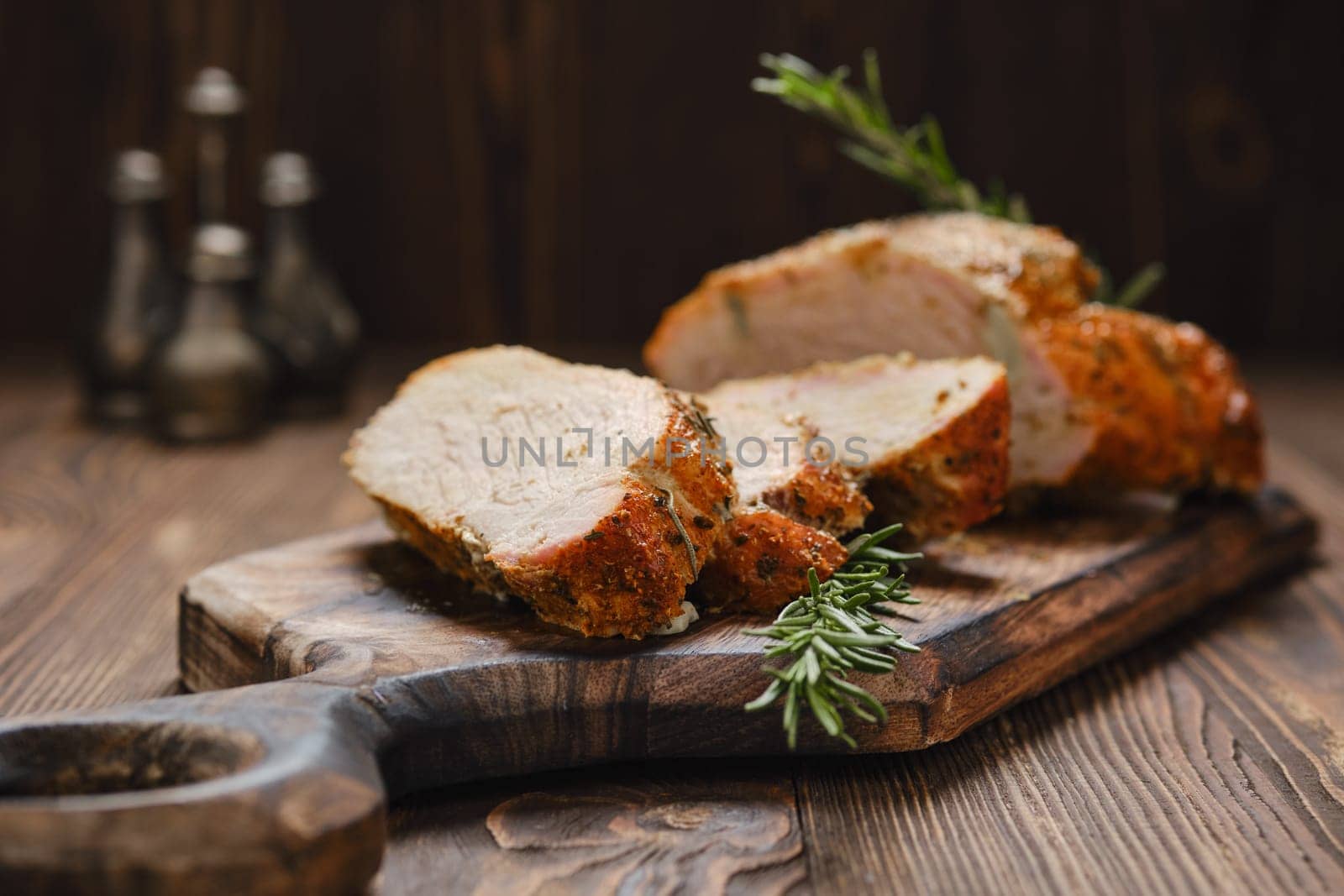 Closeup view of pork collar joint baked in oven on wooden cutting board