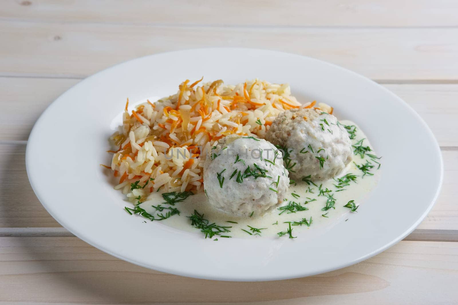 Plate with meatballs with rice and carrot.