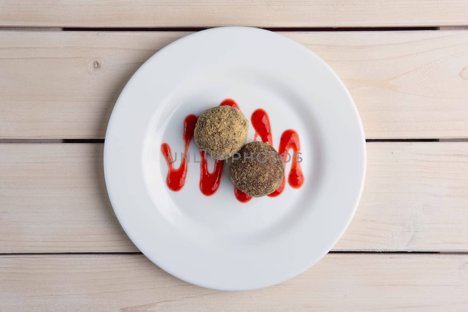 Chocolate truffles with biscuit powder. Rum balls and raspberry jam. Top view.