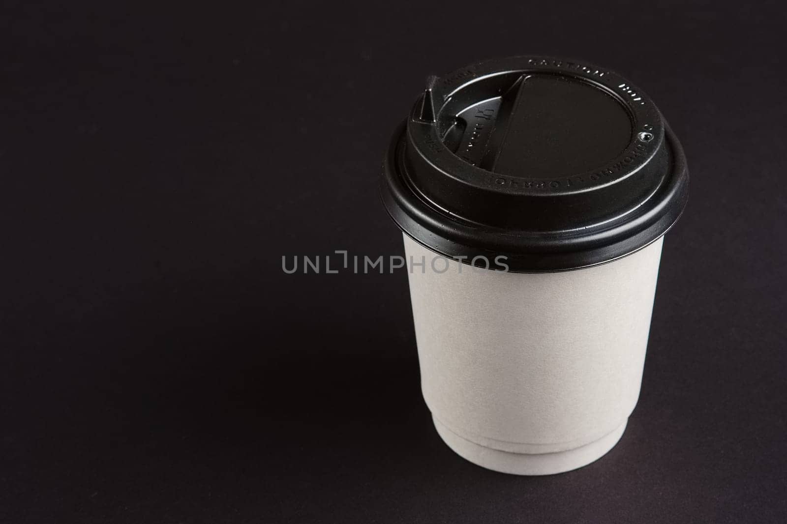Cardboard cup with lid. Place for text.