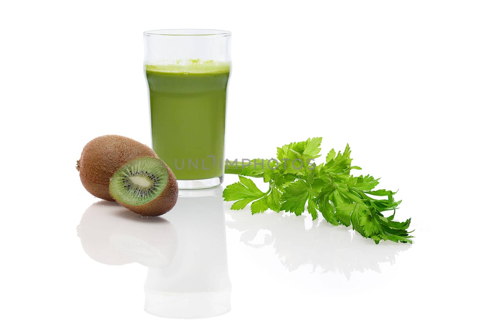 Glass of fresh kiwi, celery and apple juice with reflection on white background. Ingredient for smoothie.