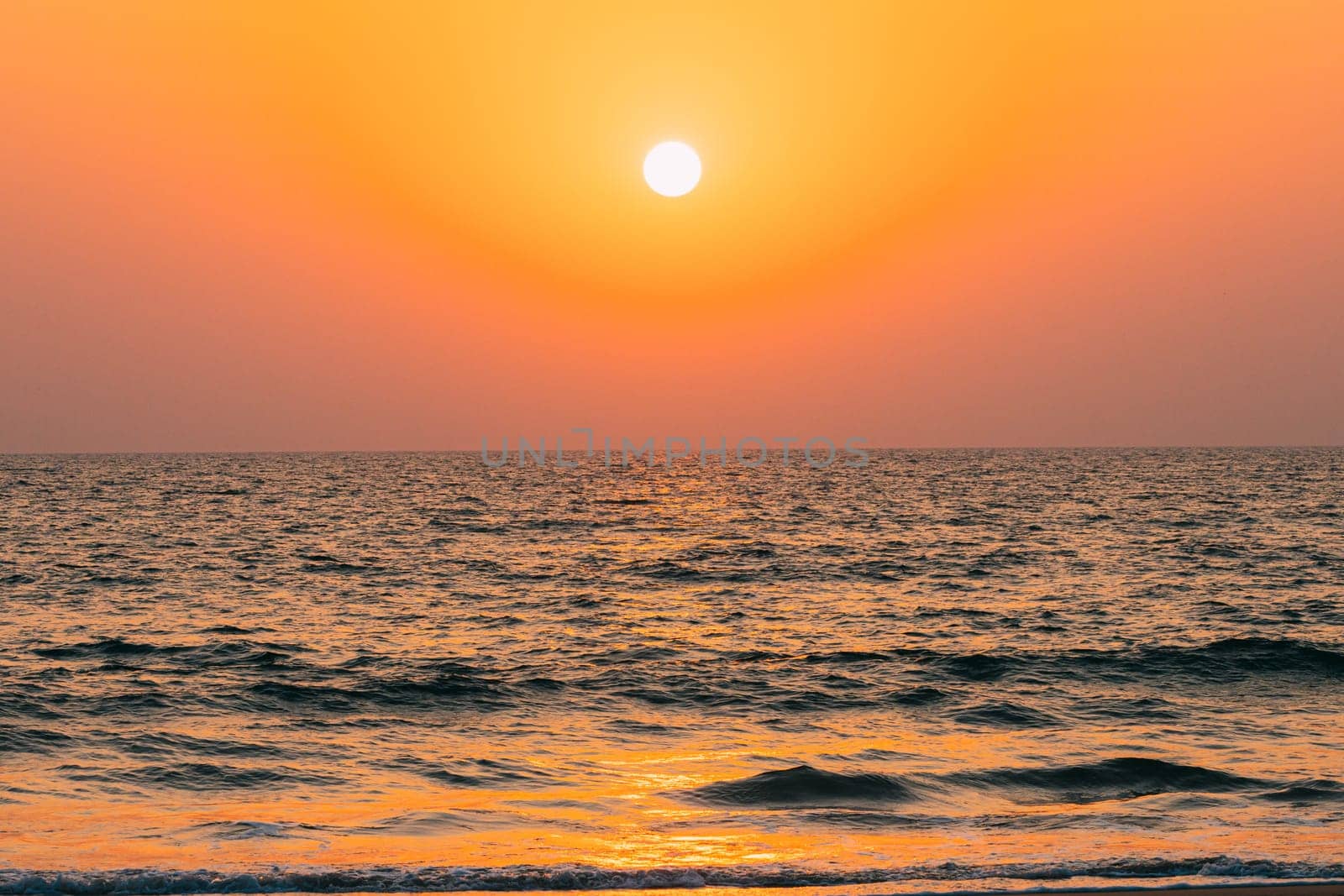 Natural Color Sunset Sunrise Sky Over Sea. Seascape With Shining Setting Sun On Sea Horizon.