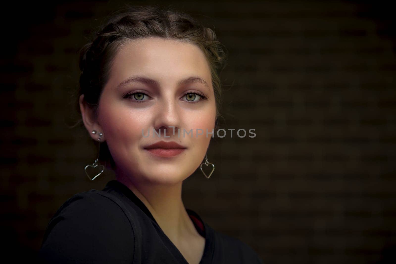 young beautiful woman black dress wearing makeup evening wear pretty girl brunette hairstyle and earring
