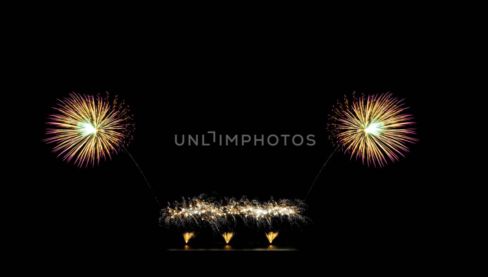 Beautiful fireworks display on black sky with copy space for greeting text. Celebration and anniversary concept