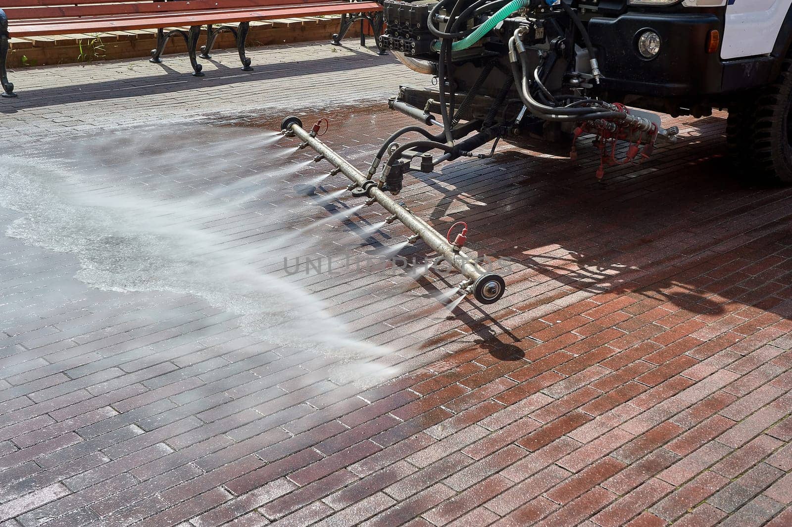 A special machine washes city paths and roads with water. High quality photo