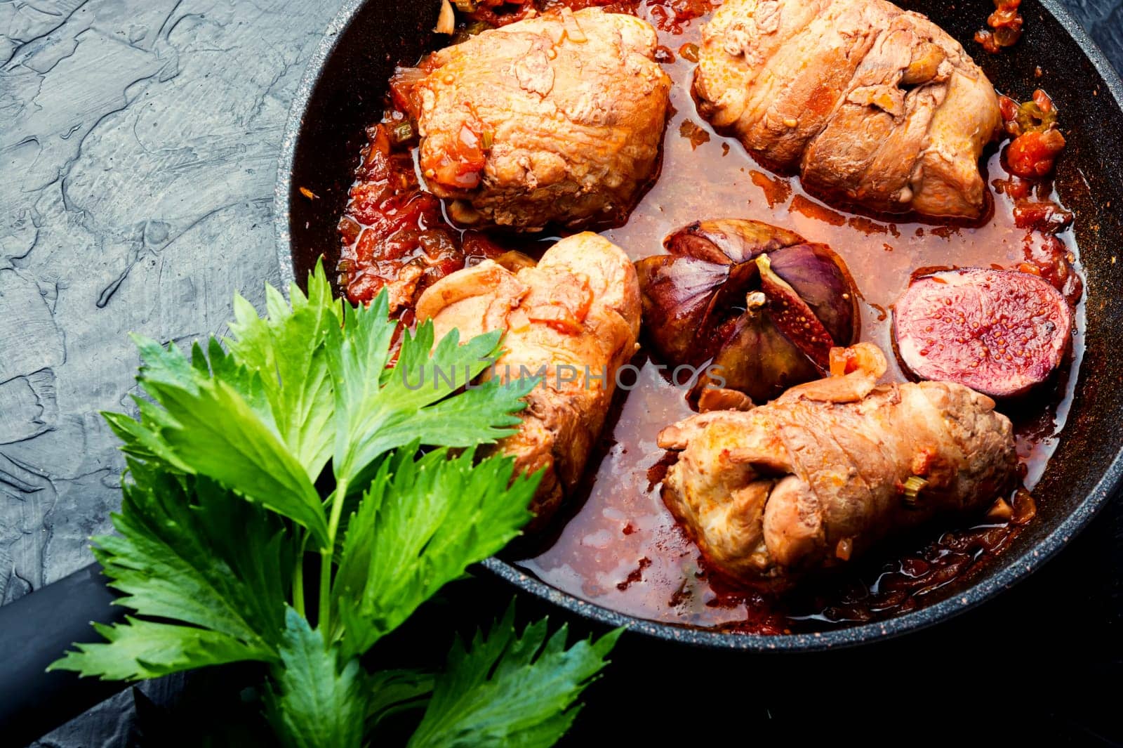 Chicken rolls with figs in wine sauce.Flat lay