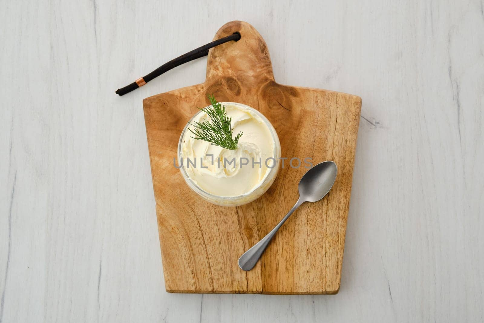 Top view of fat sour cream in a glass pot