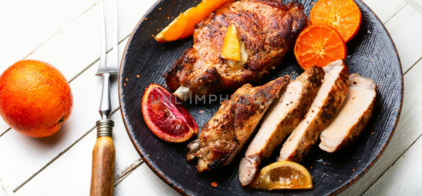 Pork cutlet on the bone grilled in oranges, lime and tangerine.